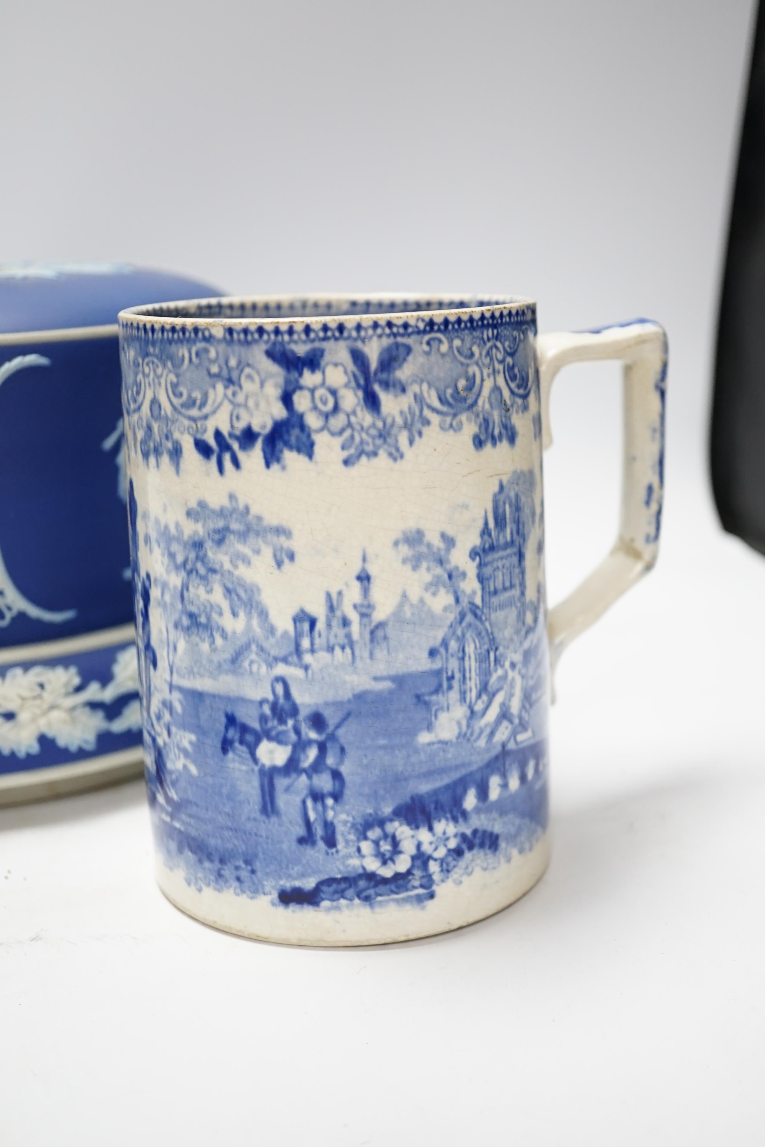 A Victorian Jasper ware cheese dome, a Wedgwood biscuit barrel and a transfer printed blue and white mug, largest 23cm in diameter